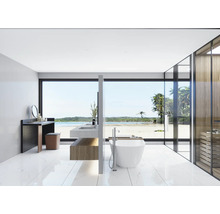 Helles Badezimmer mit Waschtisch, Spiegel, Badewanne und großem Fenster mit Meerblick