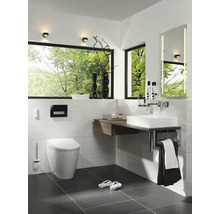 Helles Badezimmer mit Toilette, Waschbecken, Spiegel und großem Fenster