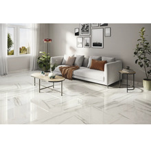 Heller Wohnraum mit Marmorfliesen, Sofa und Couchtisch.