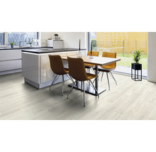 Heller Wohnraum mit Küche, Esstisch und Vinylboden in Holzoptik.