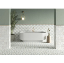 Badezimmer mit Badewanne, Fliesenboden und dekorativen Elementen