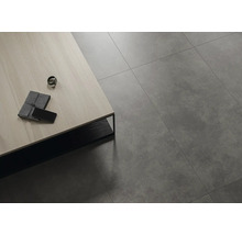 Verlegte Bodenfliesen im Innenraum mit Tisch, Notizbuch und Mobiltelefon