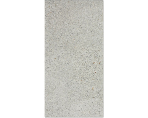 Nahaufnahme einer hellen Betonoberfläche mit kleinen Steinchen