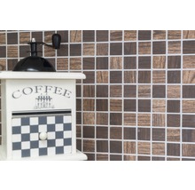 Dekorative Kaffeemühle vor Mosaikhintergrund