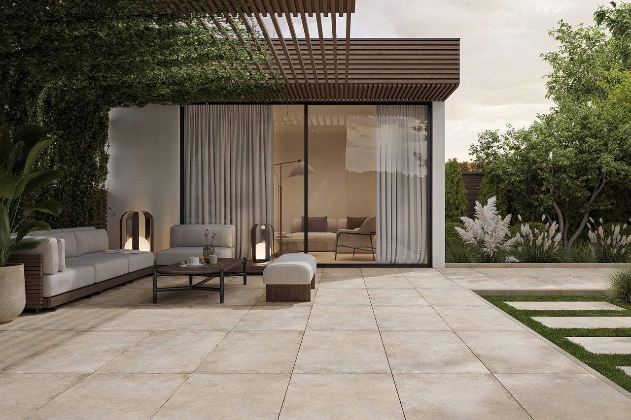 Terrasse mit Pflastersteinen, Gartenmöbeln und Begrünung für einen entspannten Aussenbereich.