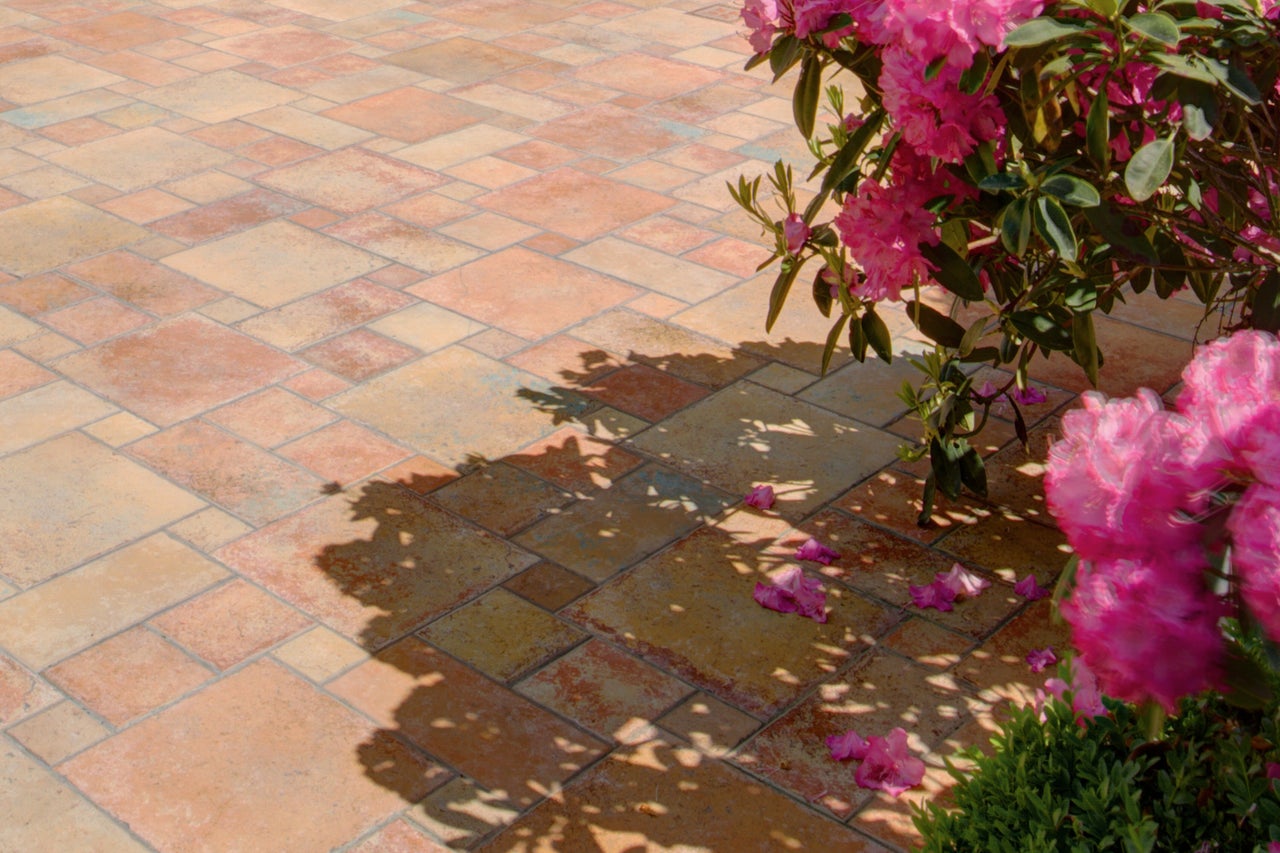 Terrassenbereich mit Pflastersteinen und Rhododendron