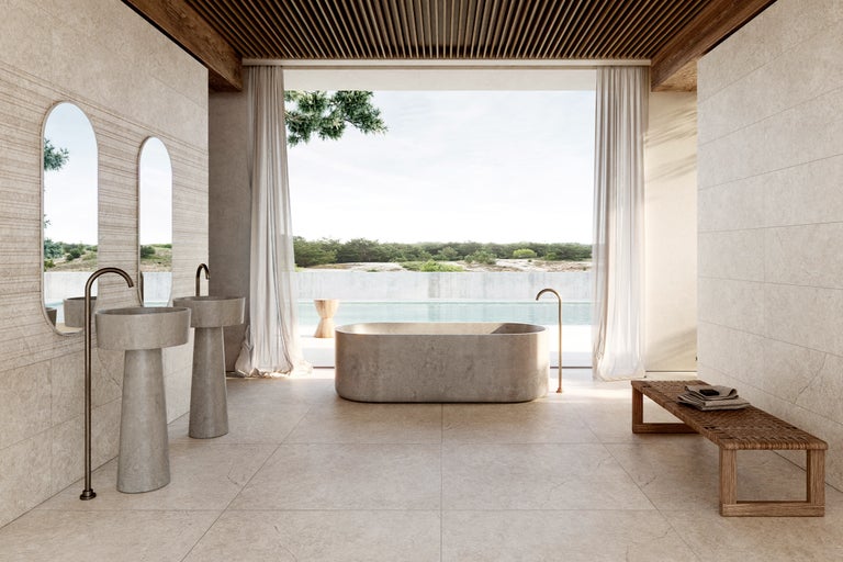 Badezimmer mit Badewanne, Waschtischen, Spiegeln und Sitzbank