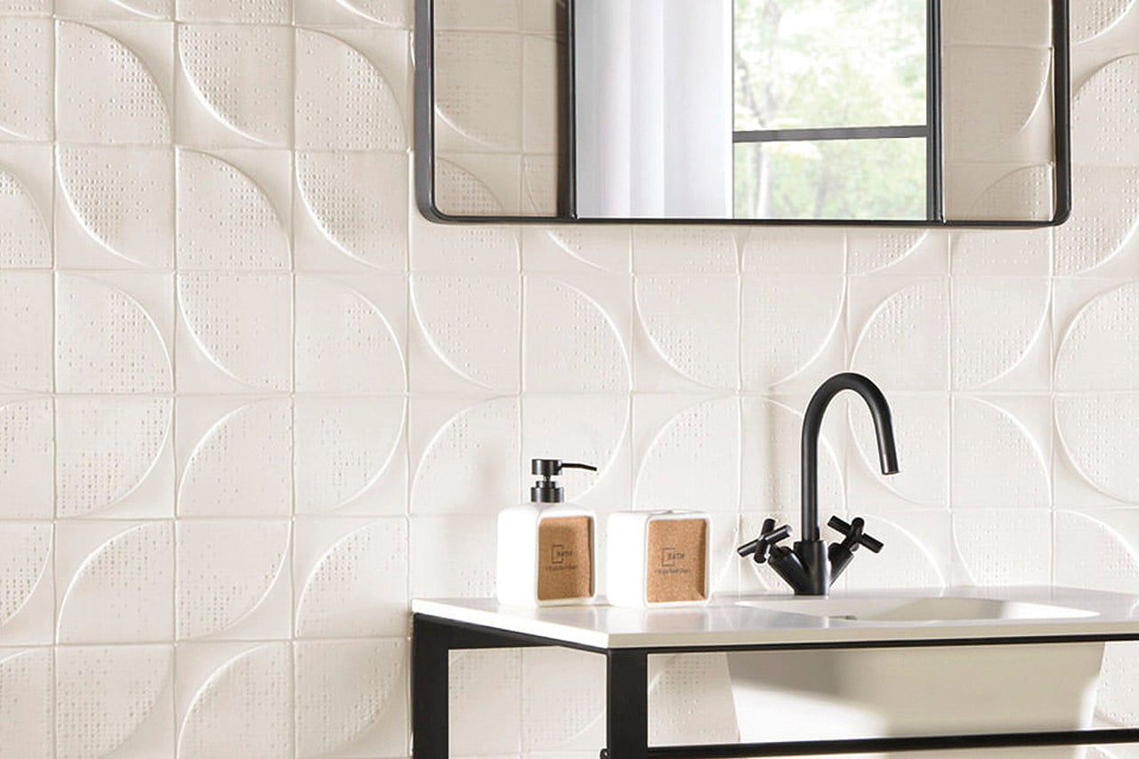 Badezimmer mit strukturierten Fliesen, Waschbecken und Spiegel